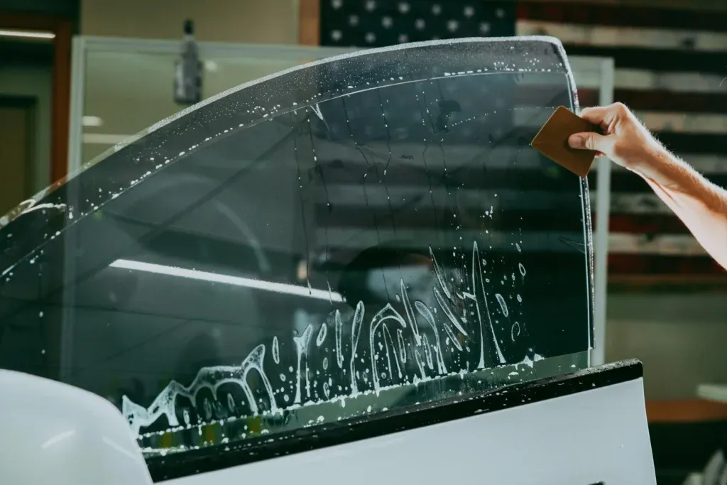 Applying window tint film on car glass