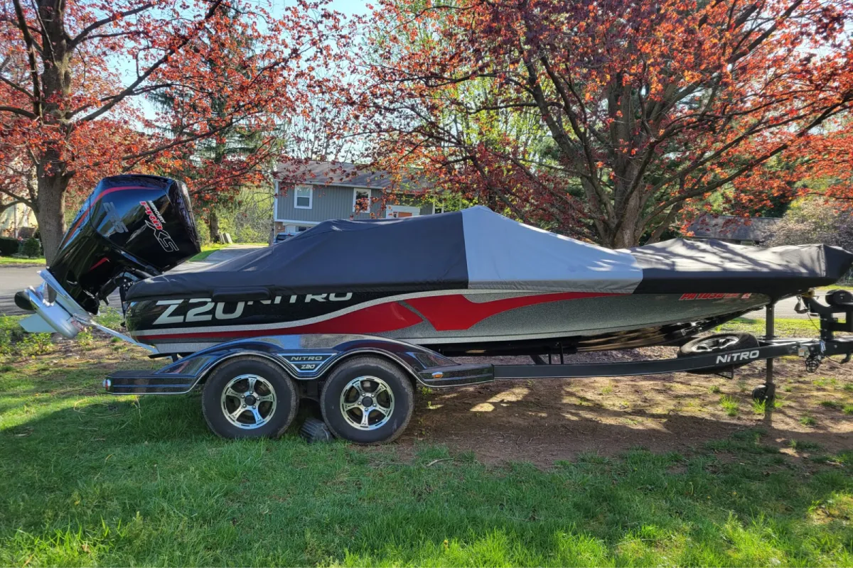 Covered Nitro Z20 bass boat on trailer outdoors