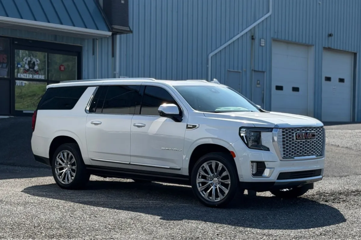 Ceramic coated white GMC Denali SUV outside a detail shop.