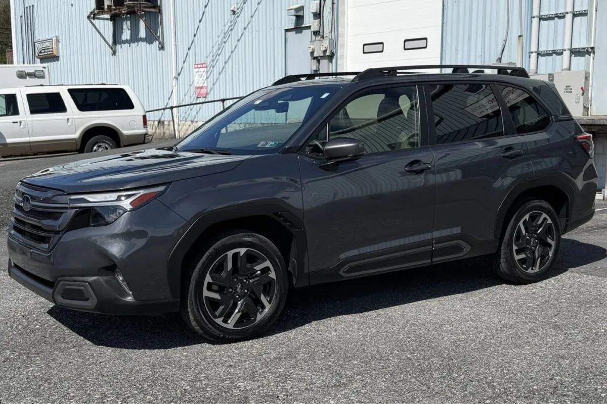 Side view of gray SUV with window tint in parking lot