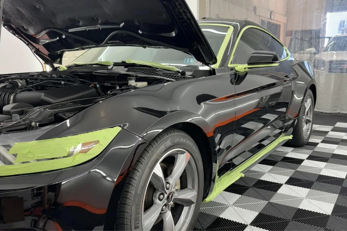 Black sports car prepared for professional auto detailing.