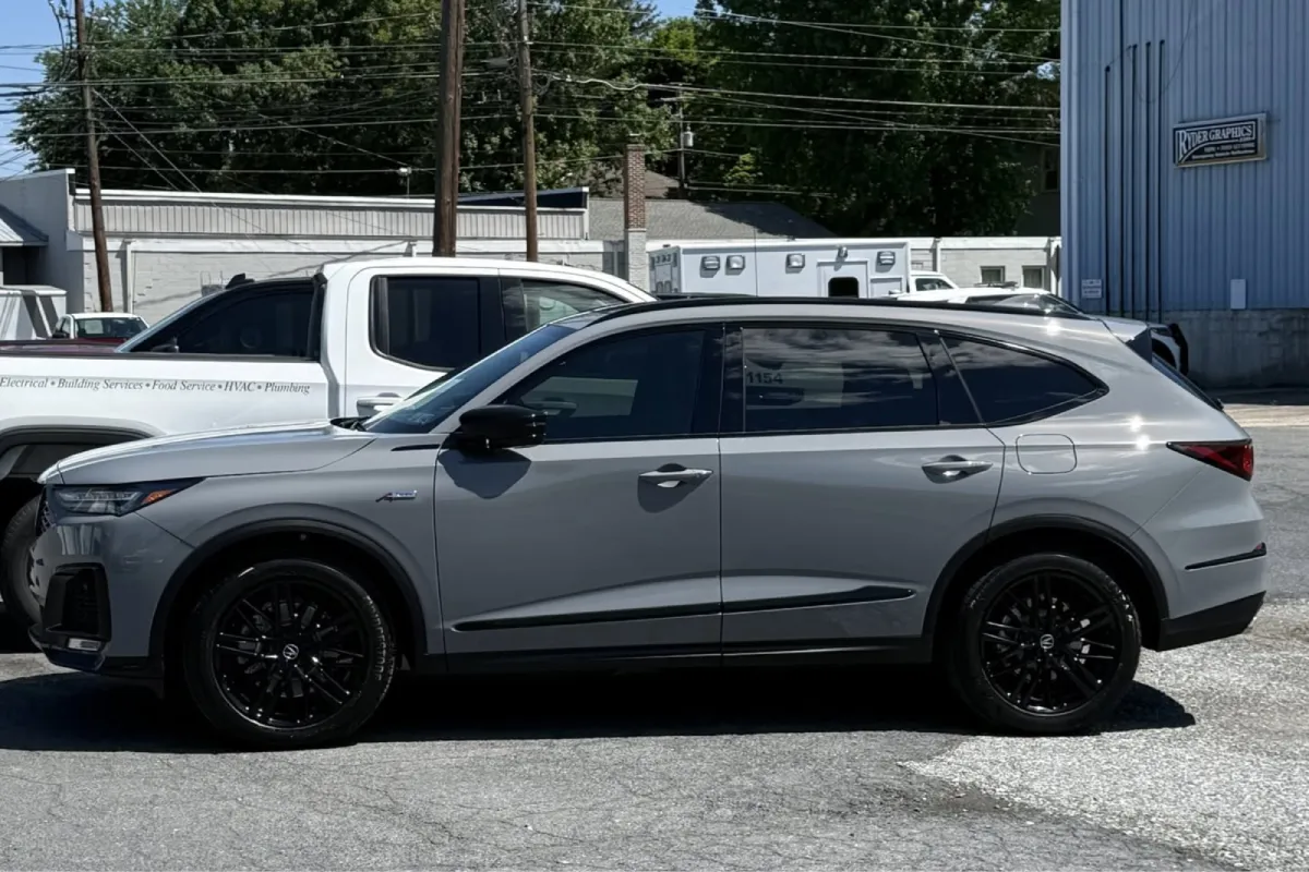 Silver SUV with dark window tint.